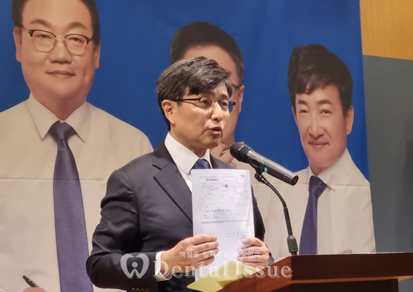 치협 33대 선거에서 김민겸 당시 후보가 2,000만 원에 대한 의혹이 부당하다며 근거서류를 들어보이고 있다.